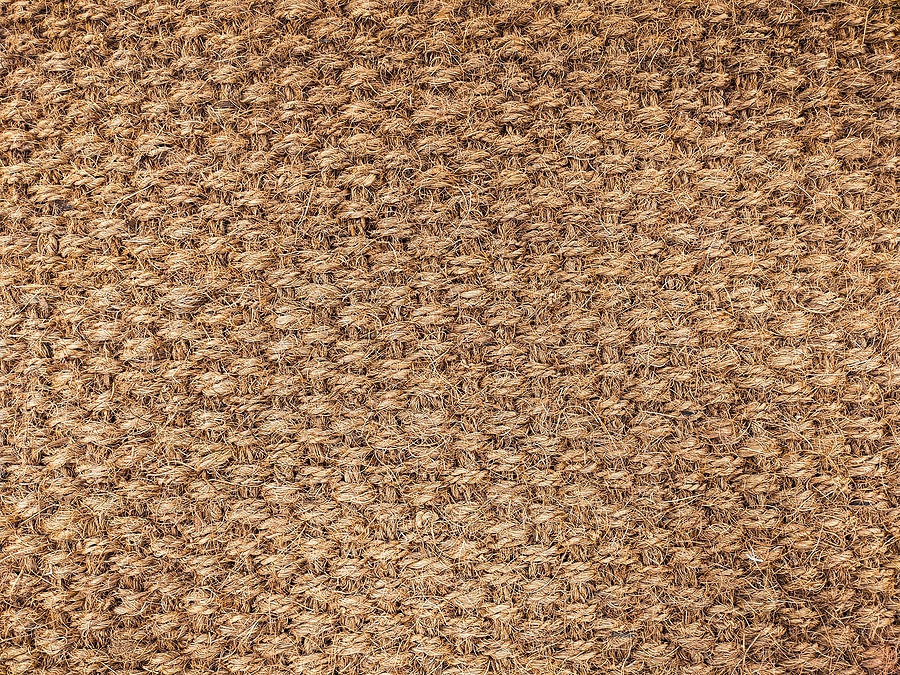 Jute rug close-up. The jute weave is close. Fragment of large weaving, background, texture. Lint-free carpet.
