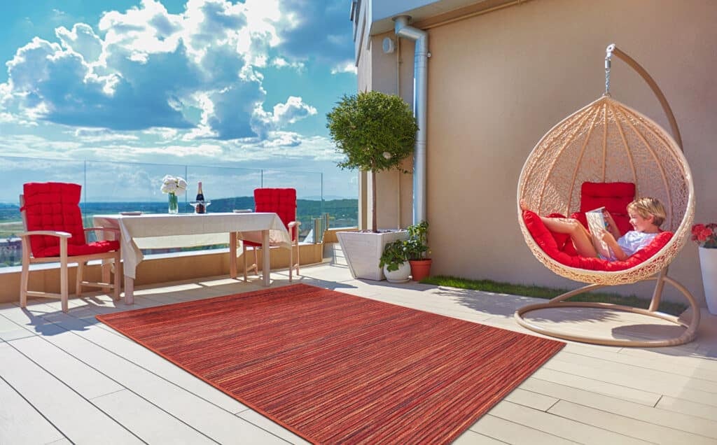 young boy relaxing in hammock on modern rooftop patio, home terrace