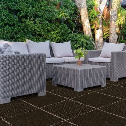 large black outdoor rug under patio furniture