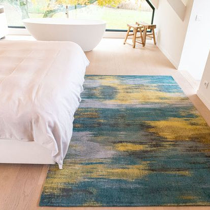 blue and yellow rug in a bedroom