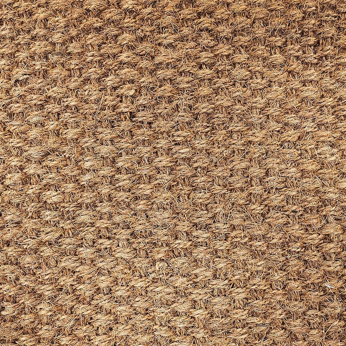 Jute rug close-up. The jute weave is close. Fragment of large weaving, background, texture. Lint-free carpet.