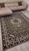 Asimah S.| Decorative rug with intricate patterns in a living room setting.