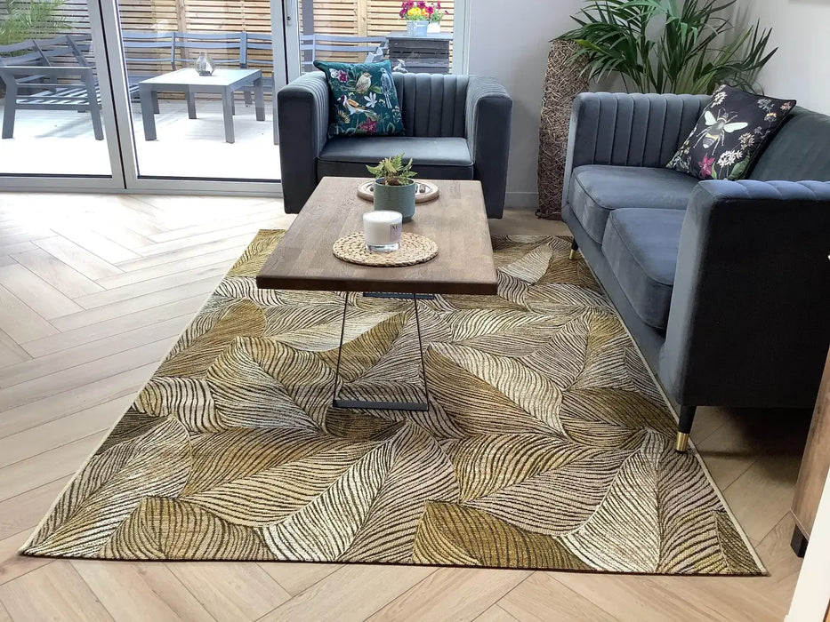 Photo By Gillian M. | Living room with a patterned rug, gray sofa, and wooden coffee table.