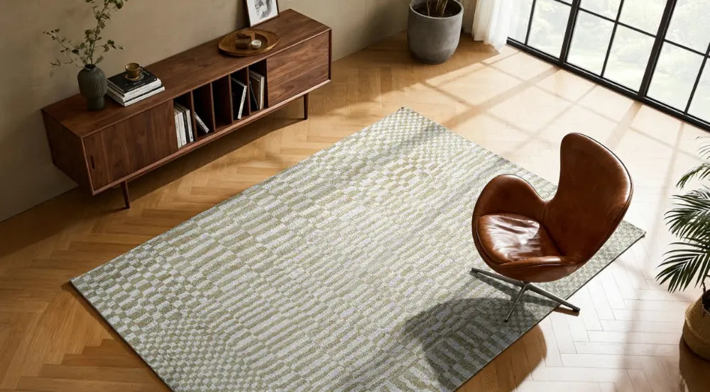 Living room with a textured rug, wooden sideboard, and brown chair.