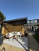 Photo By @lydford20 |Outdoor patio area with furniture and a pergola on a sunny day.
