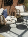 Photo by @lydford20 | Outdoor patio with wicker chairs, cushions, and a dog resting on one of the chairs.
