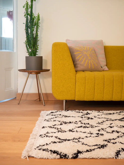 Photo By Nick A | Yellow sofa with a decorative pillow in a living room setting.