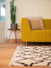 Photo By Nick A | Yellow sofa with a decorative pillow in a living room setting.