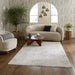 A large, rectangular area rug in a textured off-white/cream shag style, styled in a modern living room setting with a beige bouclé sofa, wooden coffee table, and dark wood floors.