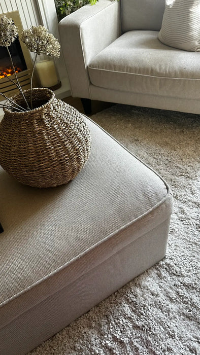 Photo By @mydreamhome_usplus6 | Beige sofa with a woven basket and decorative flowers on a carpeted floor.