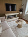 Photo by @rebeccasglamhome |Living room with a sofa, coffee table, and fireplace.