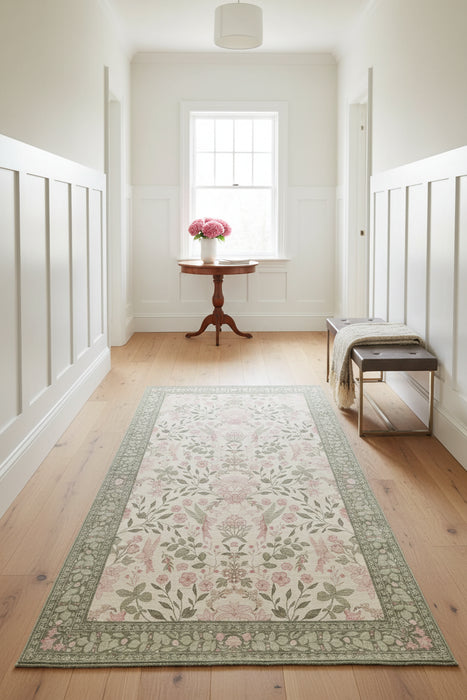 Floral patterned rug on a wooden floor in a living room setting.
