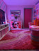 Photo by @aggielang | Colourful room with pink walls, a red door, and a patterned rug.