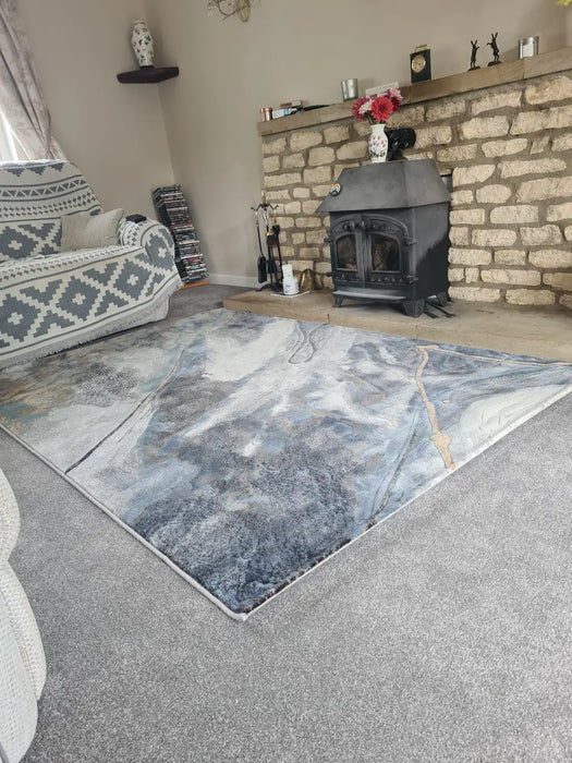 Photo By Vikki P. | Living room with a patterned rug, sofa, and brick fireplace.