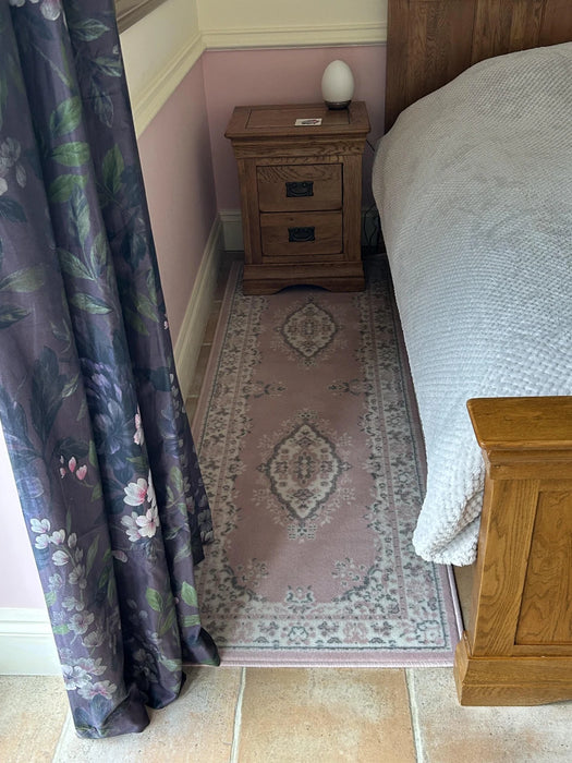 Photo By Elaine F. | Bedroom with floral curtains, wooden nightstand, and patterned rug.