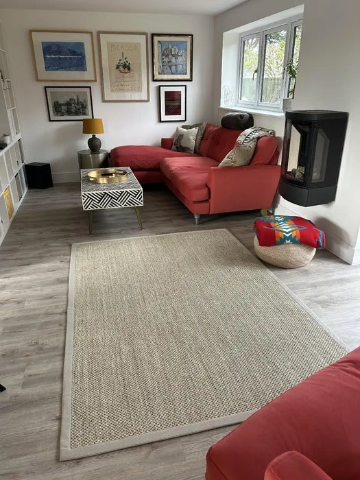 Photo By Sally J | Living room with red sofa, sisal rug, and decorative items