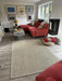 Photo By Sally J | Living room with red sofa, sisal rug, and decorative items