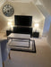 Photo By Joyce N. | Modern living room with a television, clock, and table.