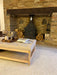 Photo By @renovatingtudorlodge | Living room with a brick fireplace, wooden bench, and firewood.