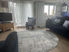 Photo By Sue | Living room with a round grey rug.