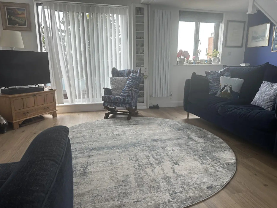 Photo By Sue | Living room with a round grey rug.