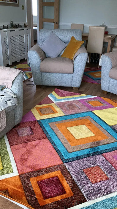 Photo By Cathertine O. | Multicolored patchwork rug in a living room with furniture.
